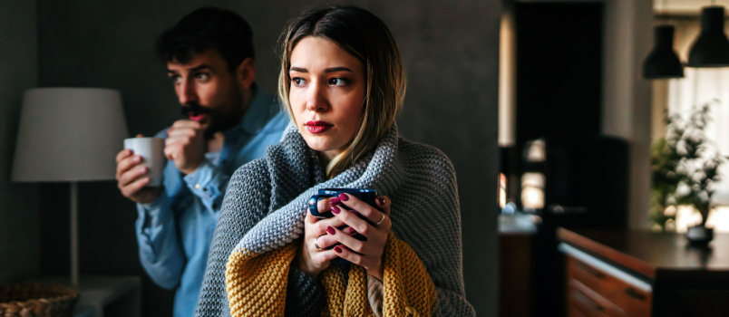 Freezing man and woman suffering from cold