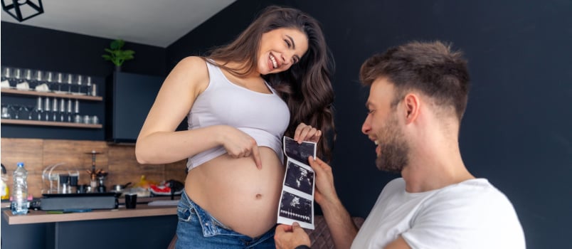 Excited father holding ultrasound