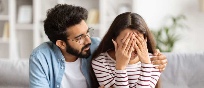 Man com forting sad girlfriend