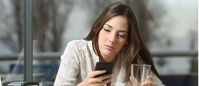 Angry woman sitting alone in coffee shop