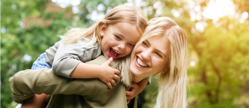 Cute young daughter playing with mom