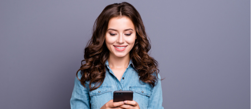 Cheerful woman texting