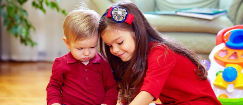 Girl playing with little brother
