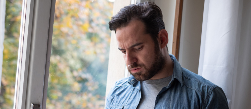 Sad man watching smartphone
