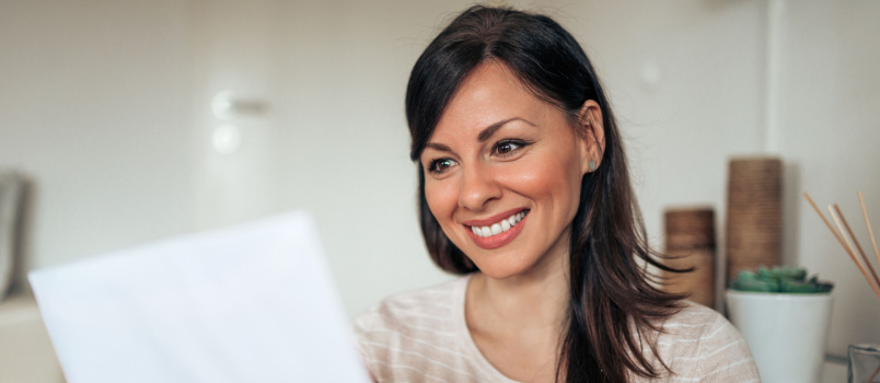 Woman happily reading letter