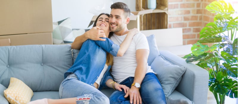 Happy couple hugging love on couch