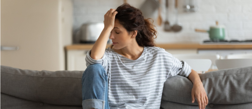 Depressed woman sitting on couch