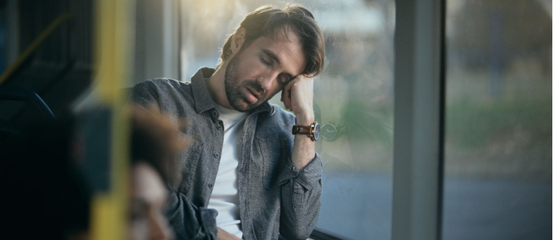 Sad man sitting beside the window