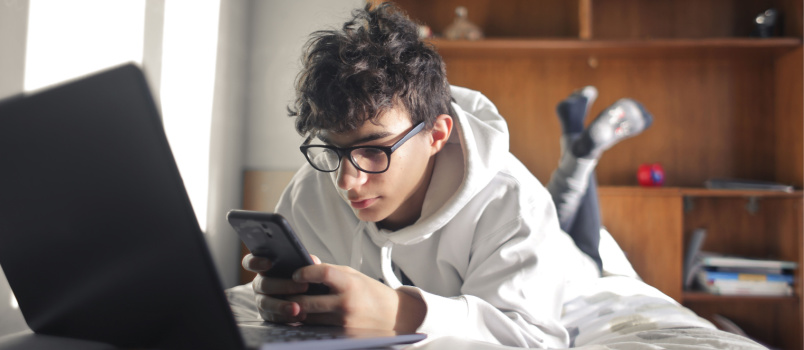 Man using phone laptop  at home