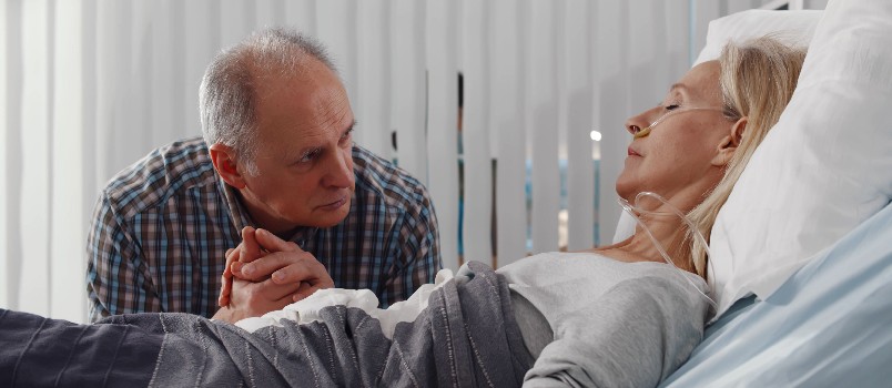 Senior man visiting wife in hospital