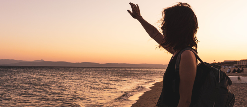 Sad woman standing alone seaside