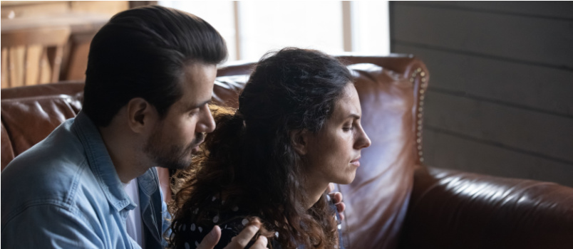 Husband comforting sad wife