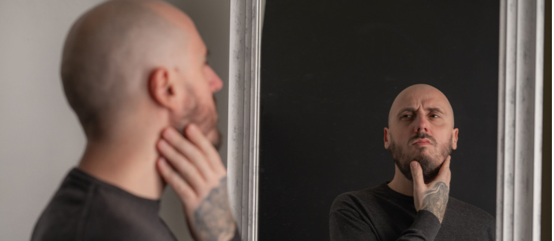 Man looking himself in mirror