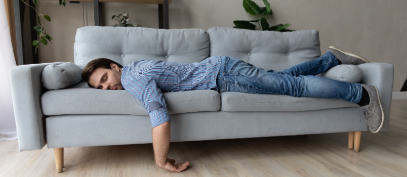 Exhausted young man fall on bed
