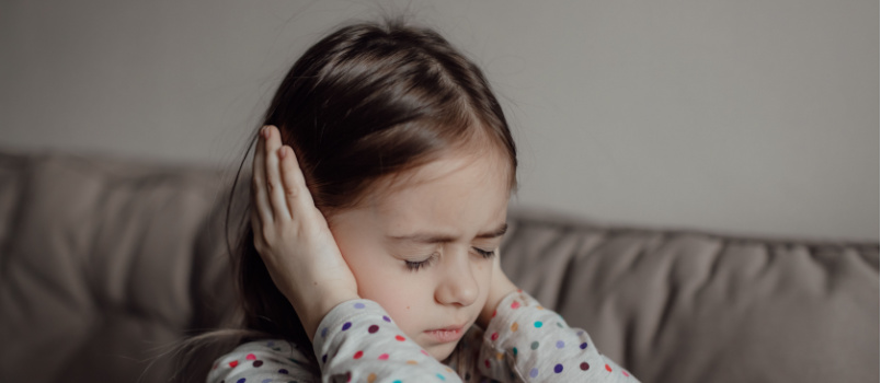 Girl shutting her ears with hands