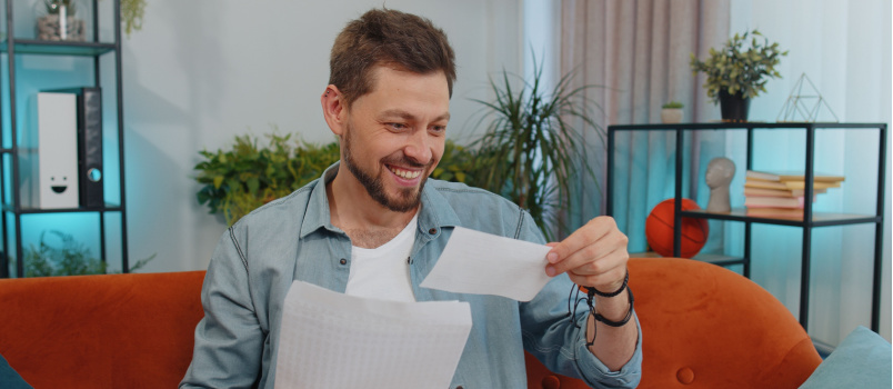 Happy guy opening envelope