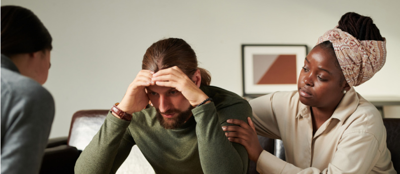 People comforting sad man