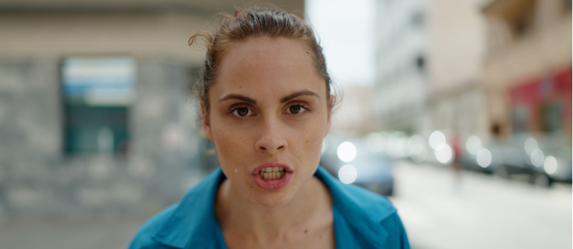 Young angry woman standing on street