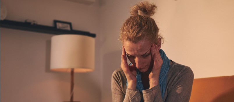 Depressed woman sitting on couch