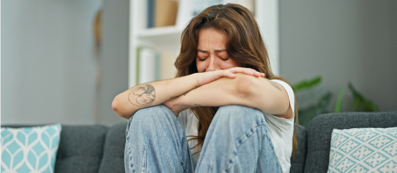 Sad depressed woman sitting alone
