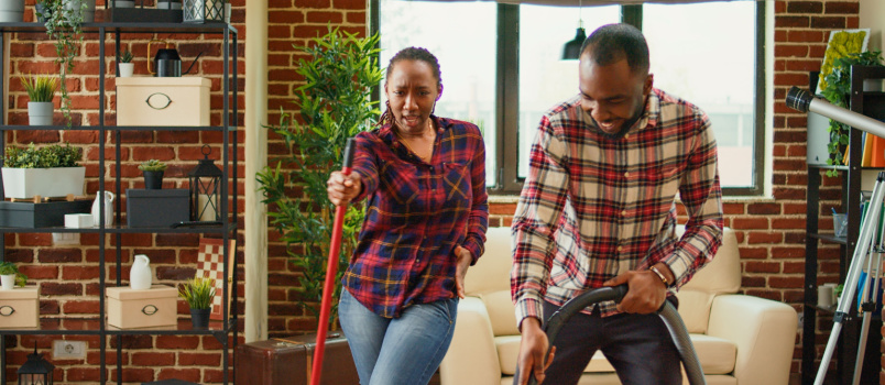 Couple having fun while doing household work