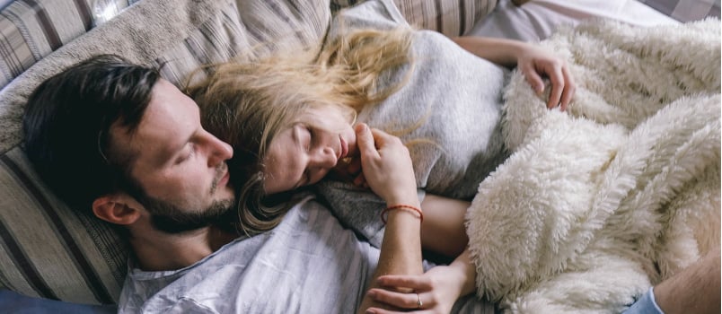 Young couple embracing each other on bed