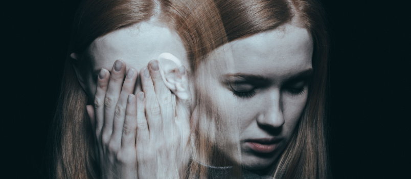 Young girl covering her face with hands