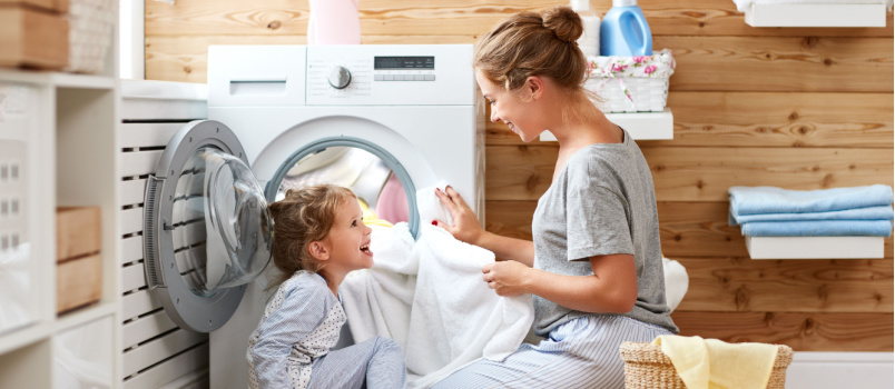 Mother and children doing laundry together