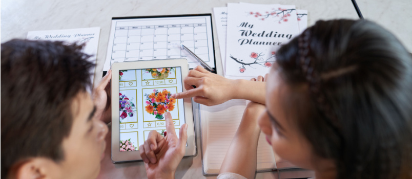 Young couple doing wedding planning