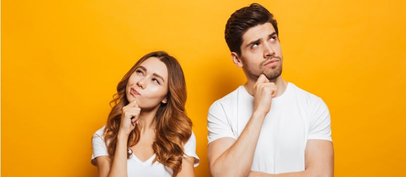 Man and woman standing thinking