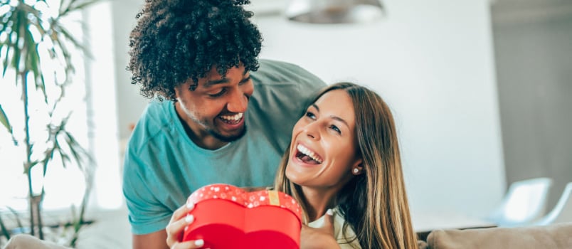 Man surprising woman with gifts