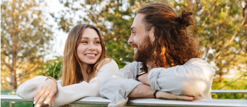 Happy couple smiling while looking at each other