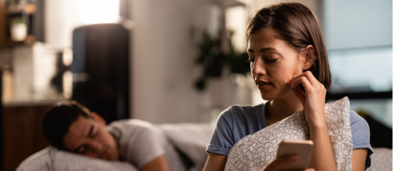Woman checking boyfriend phone
