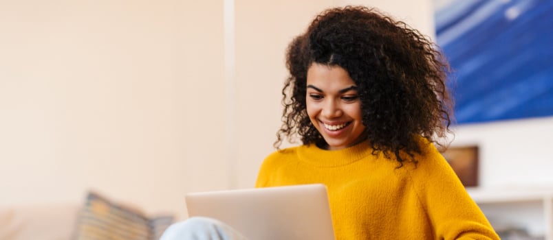 Cheerful woman using laptop