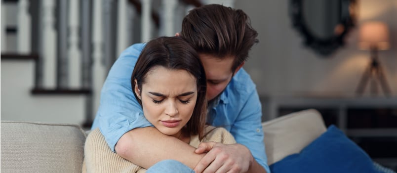 Worried man apologizing to woman