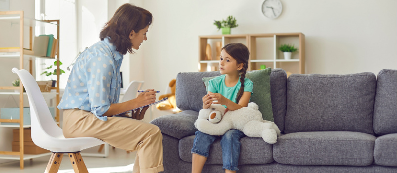 Female psychologist talking to kid