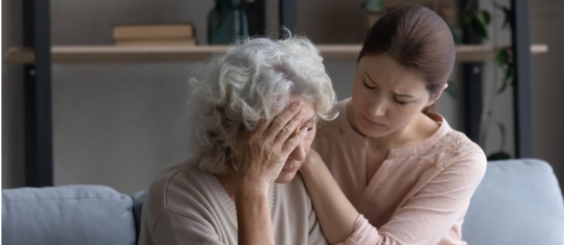 Daughter comforting sad crying mother