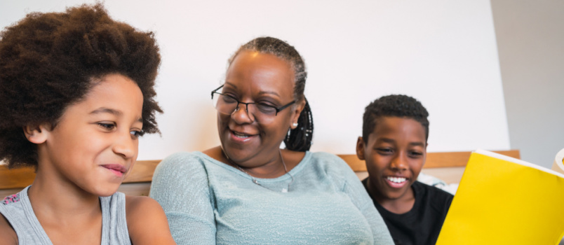 Grandmother reading books with kids