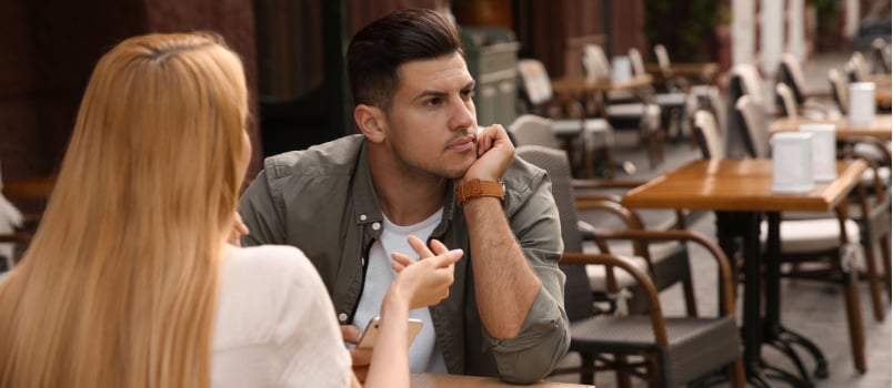 Man getting bored during first date