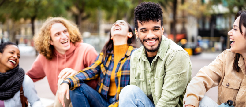 friends sitting together in city center