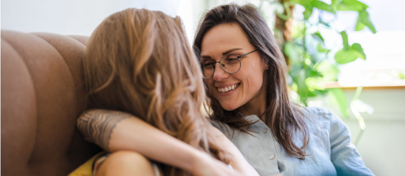 Lesbian couple relaxing on couch