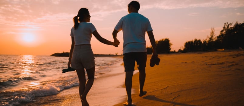 Couple holding hand moving near beach
