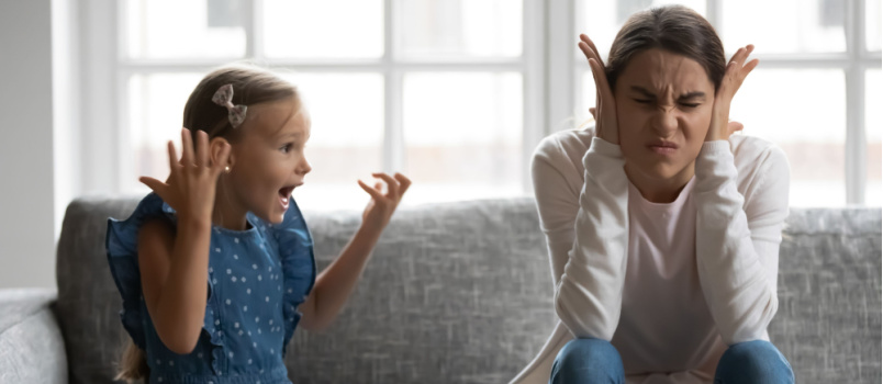 Upset mother covering her ears