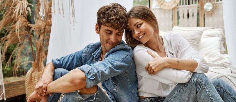 Young attractive couple sitting on floor
