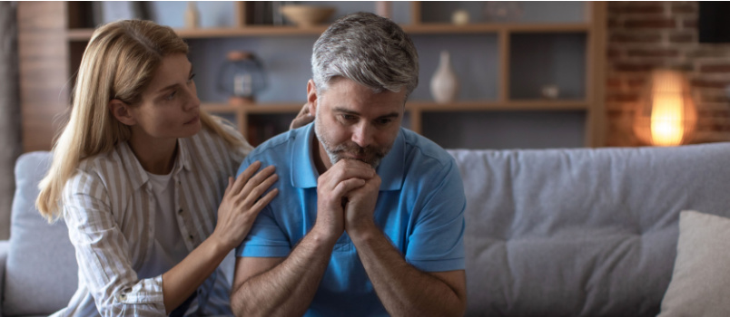 Woman comforting sad man
