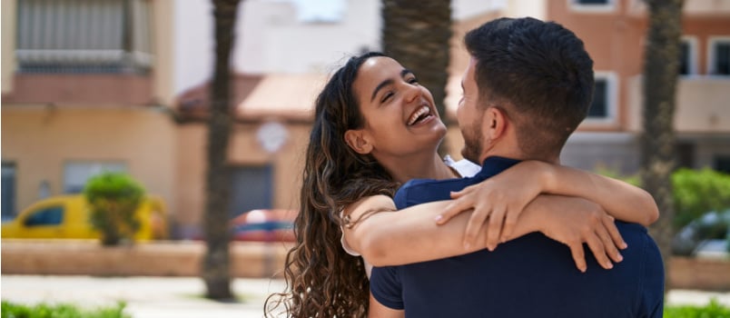 Young smiling confident couple cuddling