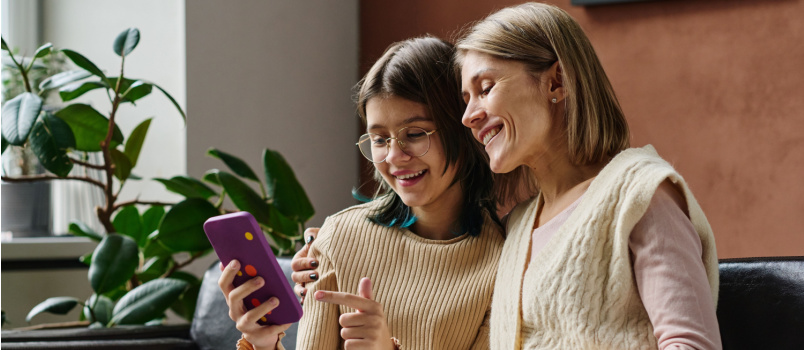 Girl showing photos to her mom
