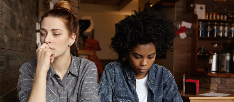 Unhappy lesbian couple talking to each other