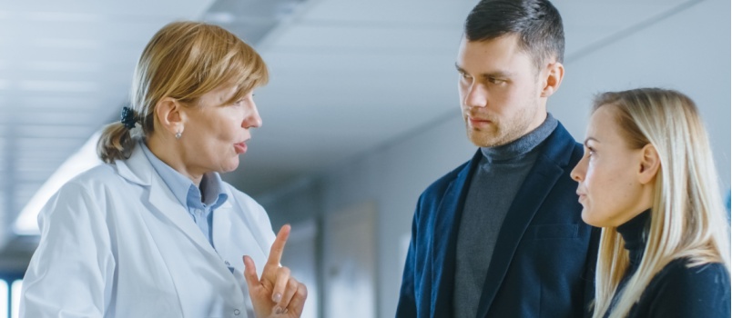 Couple meeting Doctor at reception
