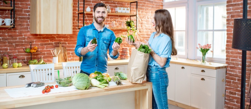 Couple unpacking fresh grocery